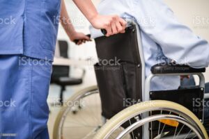 Nurse taking care of a patient on a wheelchair